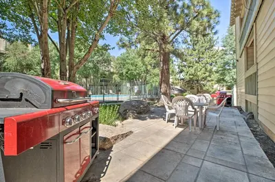a backyard with a stove and a table and chairs at Cozy Family Condo in Mammoth Lakes with Balcony in Mammoth Lakes