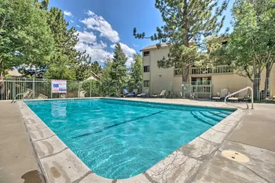 a swimming pool in front of a building at Cozy Family Condo in Mammoth Lakes with Balcony in Mammoth Lakes