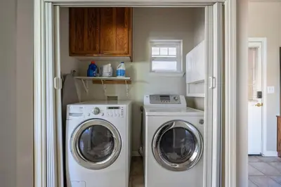 a laundry room with a washing machine and a washer at Fraser Family Vineyard Estate Pet-Friendly Home in Plymouth