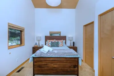 a bedroom with a bed with a wooden headboard at Tahoe Donner Luxury, Sleeps 14, Hot tub, 3100 sqft in Truckee