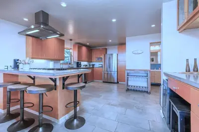 a kitchen with a large island with bar stools at Tahoe Donner Luxury, Sleeps 14, Hot tub, 3100 sqft in Truckee