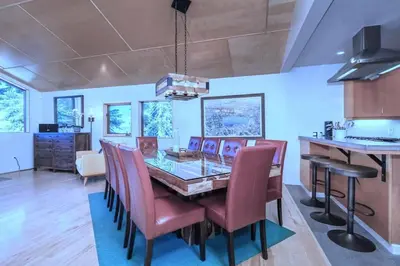 a kitchen and dining room with a table and chairs at Tahoe Donner Luxury, Sleeps 14, Hot tub, 3100 sqft in Truckee