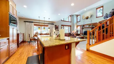 an open kitchen and living room with a large island at Timbers #10 townhouse in Mammoth Lakes
