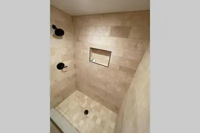 a bathroom with a shower with a tiled floor at DNA Chalet - Newly Renovated Townhome @ Northstar in Truckee