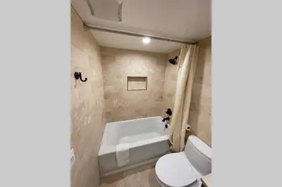 a bathroom with a tub and a toilet and a sink at DNA Chalet - Newly Renovated Townhome @ Northstar in Truckee