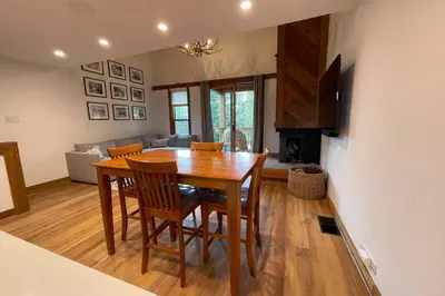 a dining room table and chairs in a living room at DNA Chalet - Newly Renovated Townhome @ Northstar in Truckee