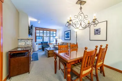 a dining room and living room with a table and chairs at Luxury Oasis Village Ski-in Ski-out in Mammoth Lakes