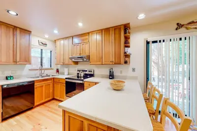 a kitchen with wooden cabinets and a counter top at Relax on Pretoria in Carnelian Bay