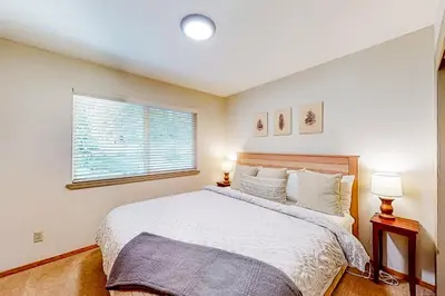 a bedroom with a large bed and a window at Relax on Pretoria in Carnelian Bay