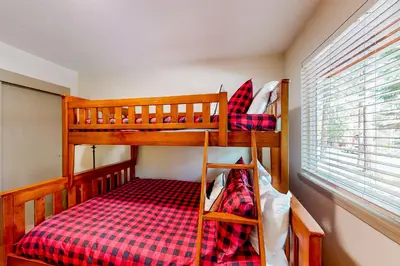 a bedroom with two bunk beds and a window at Relax on Pretoria in Carnelian Bay