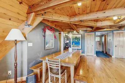 a kitchen with a wooden table in a room with wooden ceilings at Serene Lakes Splendor in Soda Springs