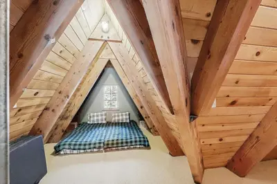 a room with a bed in a attic at Serene Lakes Splendor in Soda Springs