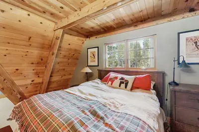 a bed in a room with a wooden ceiling at Serene Lakes Splendor in Soda Springs
