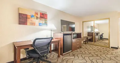 a hotel room with a desk and a chair at Best Western Roseville Inn in Roseville