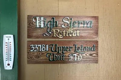 a sign on a door that reads high beam retreat upperland unit at High Sierra Retreat with a view of Pinecrest lake in Pinecrest