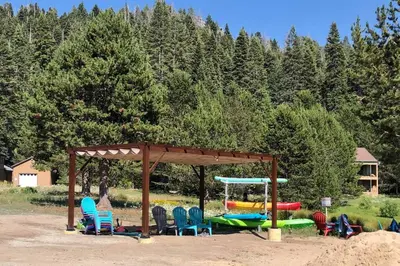 a group of chairs and a gazebo with boats at High Sierra Retreat with a view of Pinecrest lake in Pinecrest
