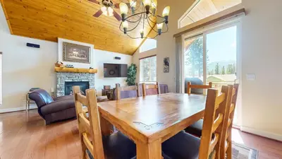 a dining room with a table and a fireplace at Mammoth Gateway Village #7 condo in Mammoth Lakes
