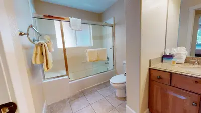 a bathroom with a shower and a toilet and a sink at Mammoth Gateway Village #7 condo in Mammoth Lakes