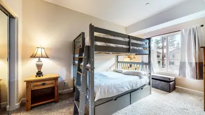 a bedroom with a bunk bed and a desk with a lamp at Mammoth Gateway Village #7 condo in Mammoth Lakes