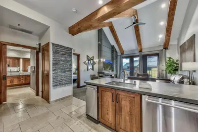 an open kitchen with wooden cabinets and a large window at Luxury Two Bedroom Residence steps from Heavenly Village condo in South Lake Tahoe