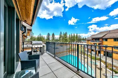 a balcony with a grill and a swimming pool at Luxury Two Bedroom Residence steps from Heavenly Village condo in South Lake Tahoe
