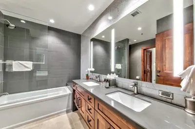 a bathroom with two sinks and a bath tub and a tubermottermott at Luxury Two Bedroom Residence steps from Heavenly Village condo in South Lake Tahoe