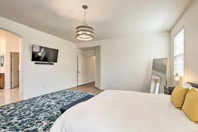 a bedroom with a bed and a tv on the wall at 12 Mi to Riverwalk District Quiet Reno Retreat in Reno