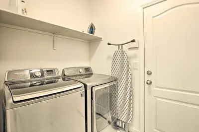 a small kitchen with a washer and dryer at 12 Mi to Riverwalk District Quiet Reno Retreat in Reno