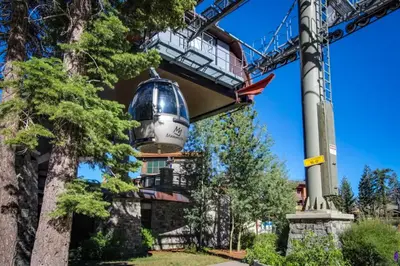 a building with a bell hanging from a crane at La Residence 8 in Mammoth Lakes
