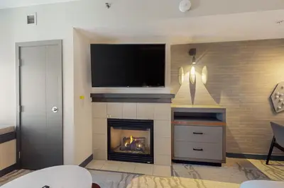 a living room with a fireplace and a flat screen tv at Westin 617 in Mammoth Lakes