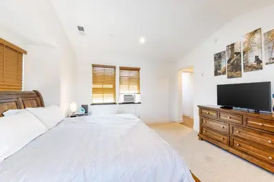 a bedroom with a bed and a flat screen tv at Creekhouse 1332 in Mammoth Lakes
