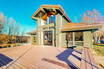 a building with a wooden deck in front of it at Creekhouse 1332 in Mammoth Lakes