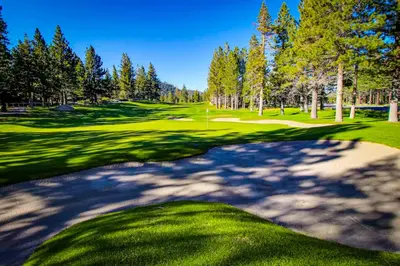 a golf course with trees and a green at Creekhouse 1332 in Mammoth Lakes