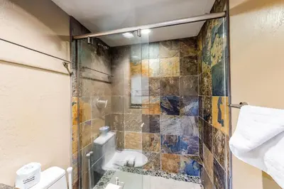 a bathroom with a shower with a glass door at Condos 1849 #102 in Mammoth Lakes