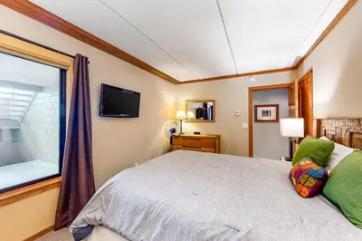 a bedroom with a bed and a window at Condos 1849 #102 in Mammoth Lakes