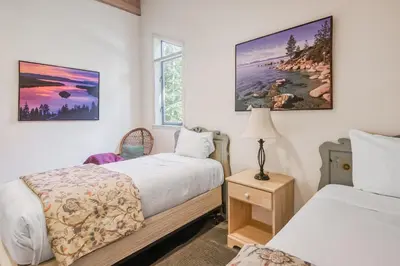 a bedroom with two beds and a window at Through the Trees in Truckee