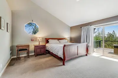 a bedroom with a bed and a window at Harvest Moon Hideaway in Groveland