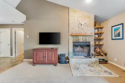 a living room with a fireplace and a flat screen tv at Harvest Moon Hideaway in Groveland