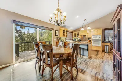 a kitchen with a wooden table and chairs and a large window at Harvest Moon Hideaway in Groveland
