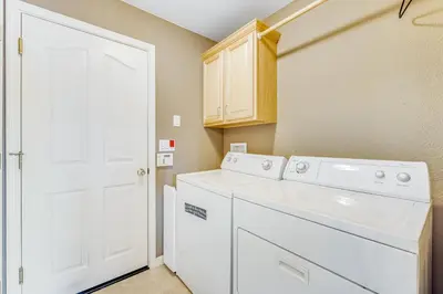 a white laundry room with a washer and dryer at Harvest Moon Hideaway in Groveland