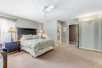 a bedroom with a bed and a ceiling fan at Harvest Moon Hideaway in Groveland