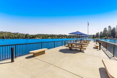 a row of benches on a pier next to the water at Harvest Moon Hideaway in Groveland