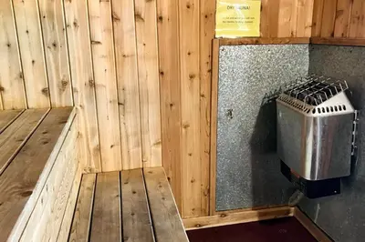 a room with a wooden wall with a trash can at Mammoth Ski & Racquet 20 in Mammoth Lakes