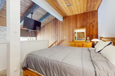 a bedroom with a bed and a television in a room at Mammoth Ski & Racquet 20 in Mammoth Lakes