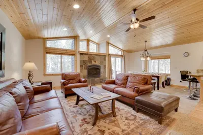 a living room with leather furniture and a fireplace at Near Donner Lake and Skiing Soda Springs Cabin! in Soda Springs