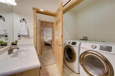 a bathroom with a washing machine and a sink at Near Donner Lake and Skiing Soda Springs Cabin! in Soda Springs