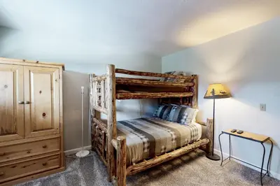 a bedroom with two bunk beds and a lamp at Mammoth View Villas 24 in Mammoth Lakes