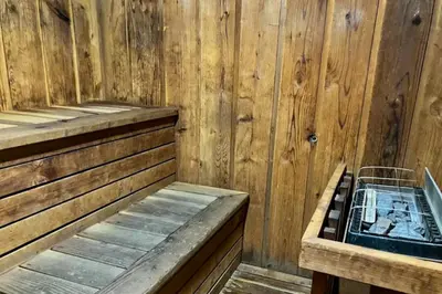 a wooden sauna with a bench and a basket at Mammoth View Villas 24 in Mammoth Lakes