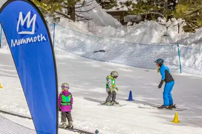 a woman and two children on skis in the snow at Mammoth View Villas 24 in Mammoth Lakes