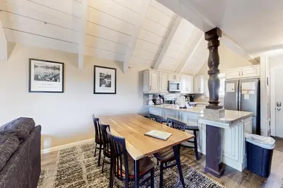 a kitchen and dining room with a wooden table at Mammoth View Villas 24 in Mammoth Lakes